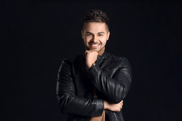 Handsome man with stylish hairdo on dark background