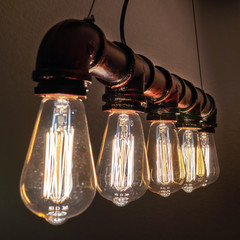An old industrial lamp in the form of old tubes and eddison bulbs