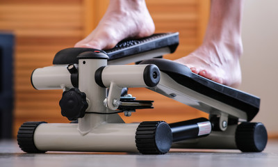 The feet of the feet press on the pedals of the rehabilitation simulator. Recovery of the ankle...
