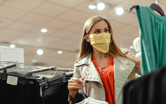 Woman shopping in fashion store wearing face mask