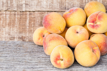 Peach fruits isolated on wooden background