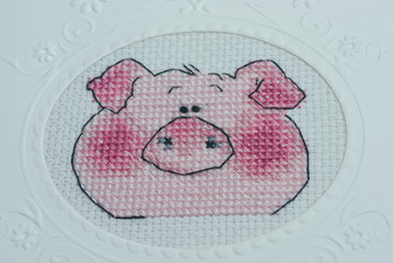 Embroidered handmade postcard by cross-stitch pattern. Muzzle pig.
