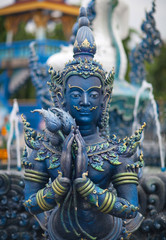 Blue statue of the Guard in Thai Lanna style - detail of exteror of Wat Rong Suea Ten, or Blue Temple in Chiang Rai Province, Northern Thailand