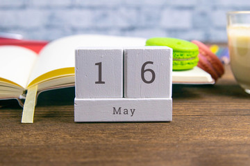 May 16 on the wooden calendar.The sixteenth day of the spring month, a calendar for the workplace. Spring