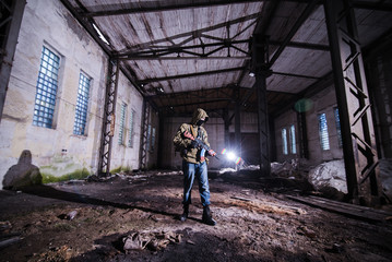 Armed warrior in empty hangar