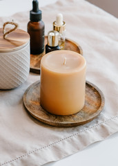Fototapeta na wymiar Aroma candles and essential oils on light background. Spa beauty concept. 