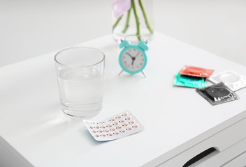 Different means of contraception on bedside table