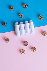 Row Of WhiteThread Spools and Small Bobbins Of Thread Used In A Sewing Machine 