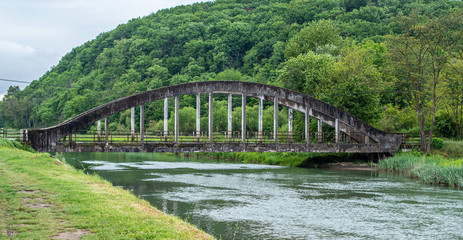 Old reinforced concrete bridge through the water channel.