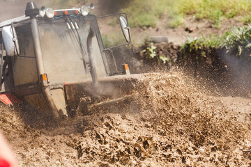 Off-road racing car driving at high speed on a dirt road with a smeared background. The concept of extrieme offroad © melnikofd