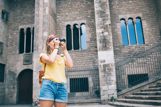 Traveling woman taking photos of ancient building