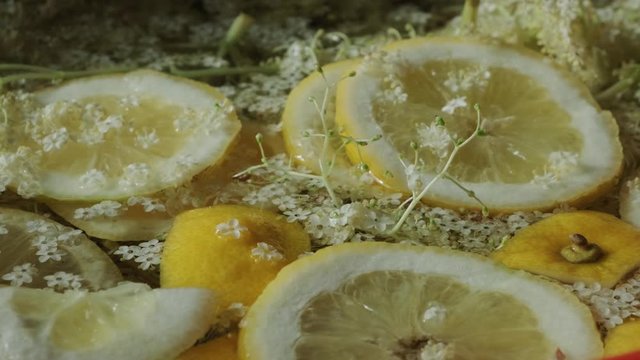 Refreshing natural drink. Lemon slices and elder flowers in water