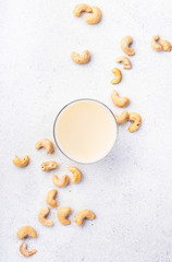 Vegan Cashew nut milk in bottles, closeup, white table background. Non dairy alternative milk. Healthy vegetarian food and drink concept. Copy space