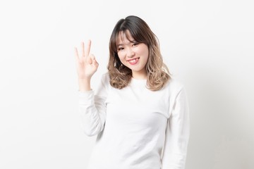 OKサインをポーズをする若い女性
