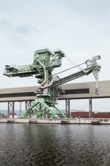 Green port crane for bulk products loading, close-up