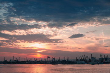 Varna port at sunset. Dark silhouettes of cranes