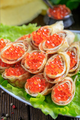 Delicious Russian dish. Pancakes with red caviar.
