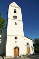 Fototapeta na wymiar Restored baroque church with a bell tower in the Drivenik, Croatia