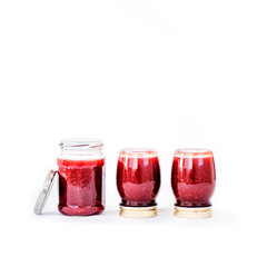 Three jars with homemade berry jam on white isolated background. Making preserves at home. Square format.