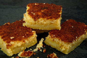 Pieces of creamy cornmeal cake. Traditional Brazilian treats made of corn