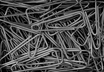 triangular metal paper clips creating a conceptual office background