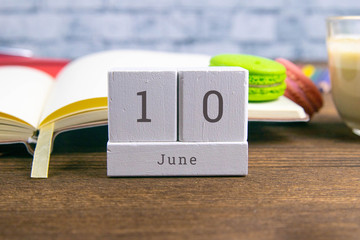 June 10 on the wooden calendar.The tenth day of the summer month, a calendar for the workplace. Summer