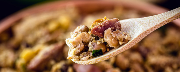 wooden spoon with portion of tropical beans, typical Brazilian food, primer plan, spot focus.