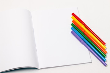 Markers form the LGBT insignia on white paper