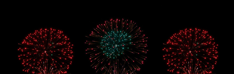 Green and red Colorful fireworks with smoke over the black sky. Low key exposure landing wallpaper.