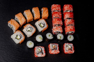 Set of sushi roll on black slate background food fish philadelphia japanese salmon delicious sushi rice cucumber meal traditional wasabi fresh healthy gourmet raw cuisine