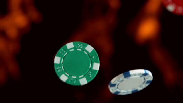 Super slow motion of rotating poker chips with flames on background. Filmed on high speed cinema camera, 1000fps.