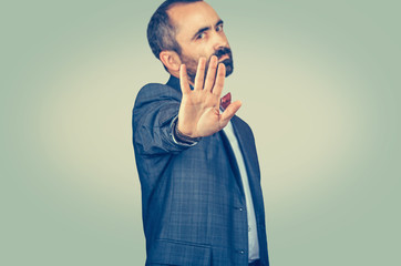 Annoyed man with bad attitude giving talk to hand gesture