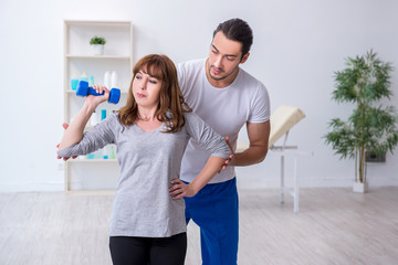 Young woman doing sport exercises with personal coach