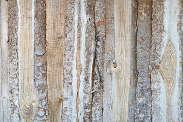 Background. Wooden unpainted fence made of rough boards.