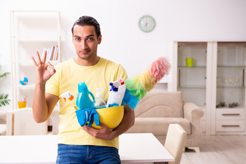 Young male contractor doing housework at home