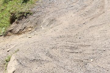 Bicycle tracks on a road with stone chips