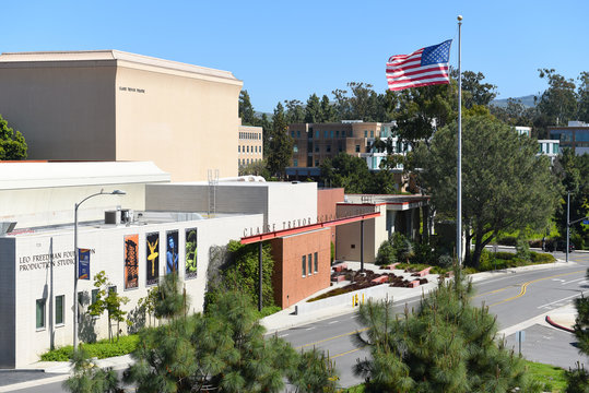 IRVINE, CALIFORNIA - 16 APRIL 2020: The Claire Trevor School Of The Arts And American Flag On The Campus Of The University Of California Irvine, UCI.