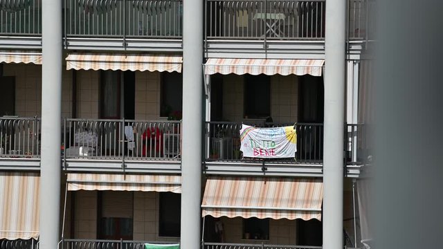 Turin, Piedmont, Italy. May 2020. Coronavirus pandemic. On the facades of the houses hang the sheets with the drawing of the rainbow and message everything will be fine. In Italian "Andr&agrave; tutto bene"