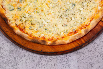 four cheese pizza on gray background