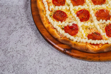 pepperoni pizza with cream cheese on gray background