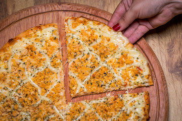 hand holding chicken pizza with Catupiry cheese,in Brazil it is called chicken pizza with catupiry cheese