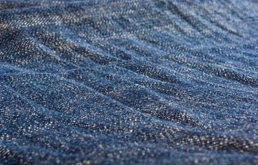 clothing items blue stonewashed faded jeans cotton fabric texture with seams, clasps, buttons and...
