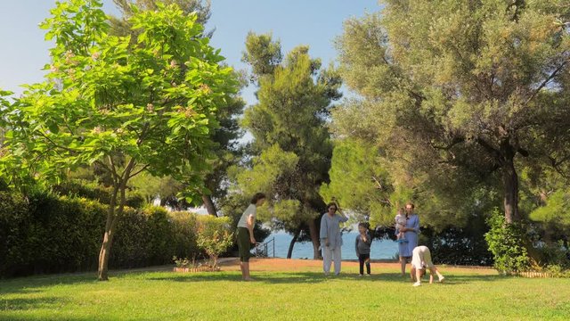 Sportive family concept. Family doing exercises on backyard. Healthy lifestyle. Morning exercises on front yard, garden. Sport outdoor. Family spending time together. Healthy lifestyle. Active people