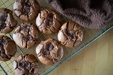 soft dark chocolate brownie cookies on a metal rack on a wooden background.