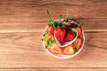 red strawberries decorated with sliced strawberries around