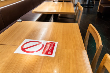 New normal with table signage prohibit occupancy to maintain social distance