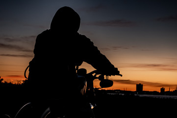 silhouette of a man on harley