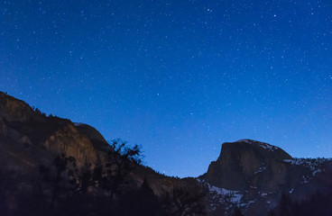Fototapeta na wymiar scene of half dome with sky at night before full moon set in Yosemite National park,California,usa.
