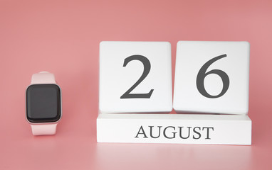 Modern Watch with cube calendar and date 26 august on pink background. Concept summer time vacation.