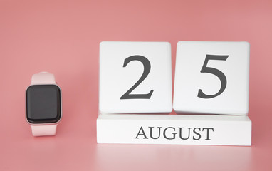 Modern Watch with cube calendar and date 25 august on pink background. Concept summer time vacation.